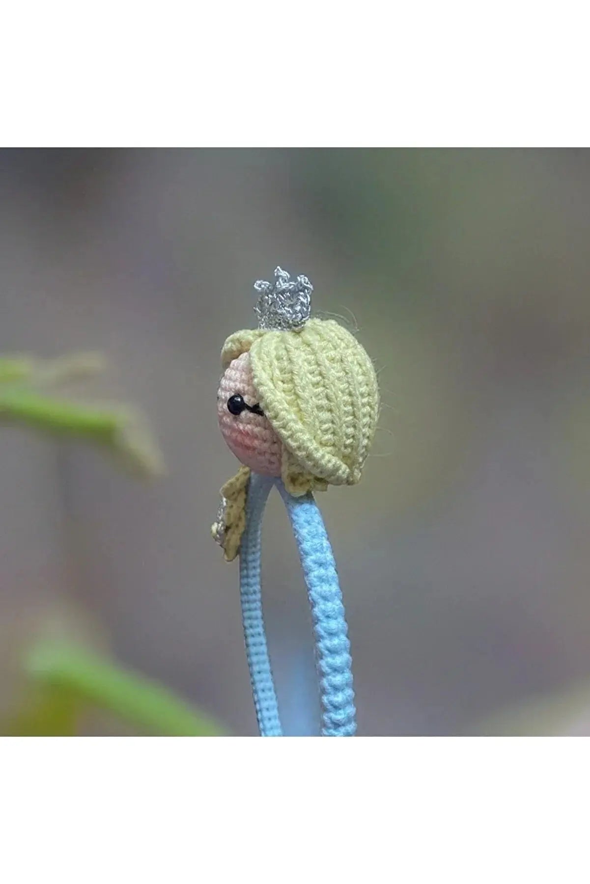 a crocheted doll with a crown on top of it's head