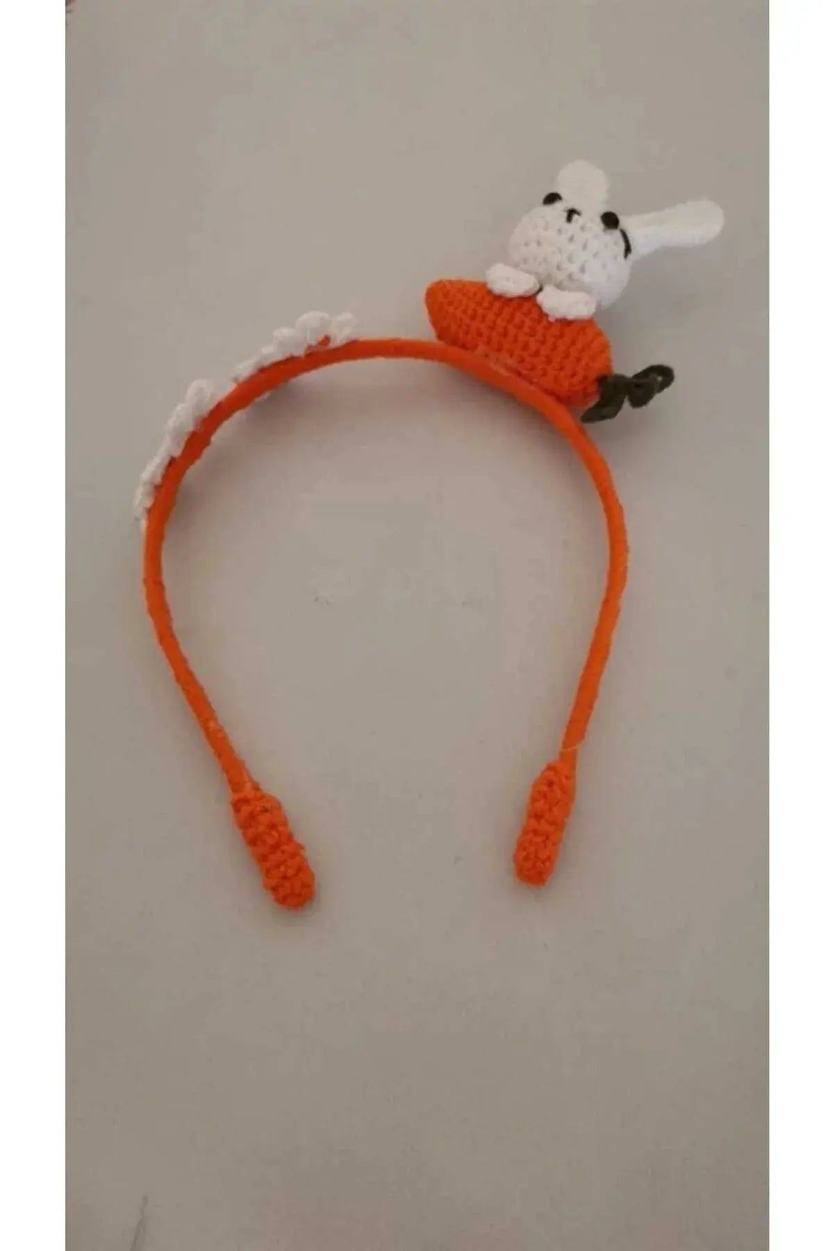 a crocheted headband with a white dog on top of it