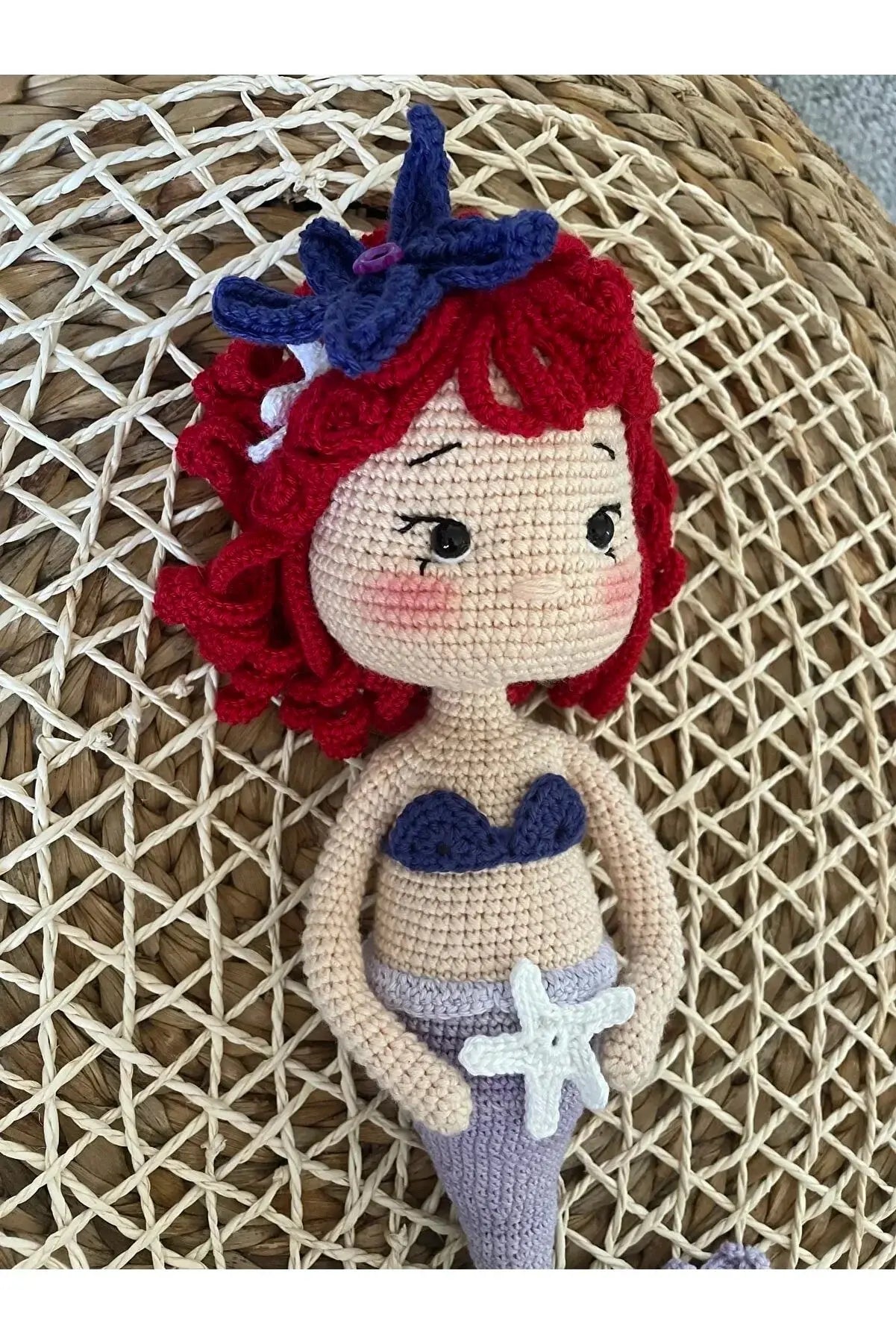 a crocheted mermaid doll sitting on a chair