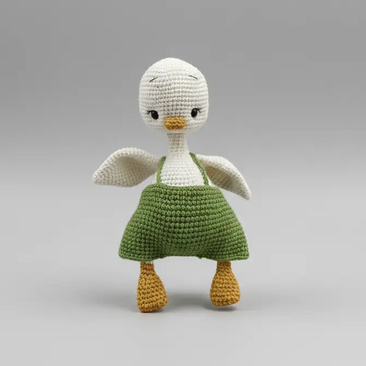 Crocheted white and green bird doll with yellow beak and feet
