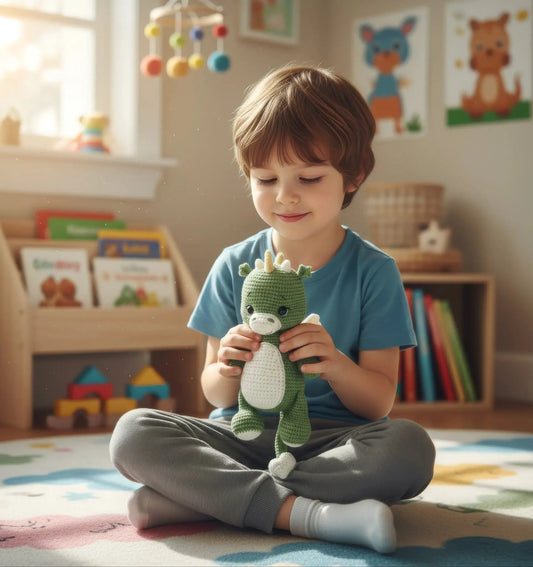 Child sitting cross-legged, smiling and holding green crocheted dinosaur in cozy playroom