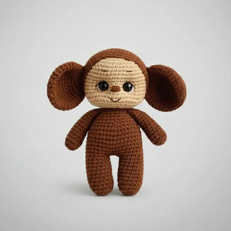 Crocheted brown and tan stuffed animal with big ears and cute expression