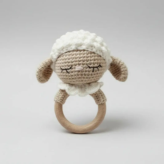 Crocheted sleepy lamb baby rattle with wooden ring, soft neutral colors
