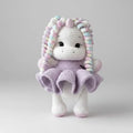Crocheted unicorn doll with curly rainbow hair and lavender ruffled dress