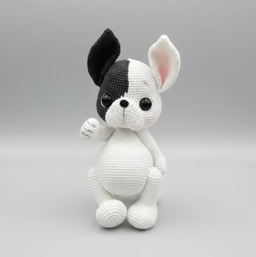 Crocheted black and white bunny with cute button eyes sitting upright