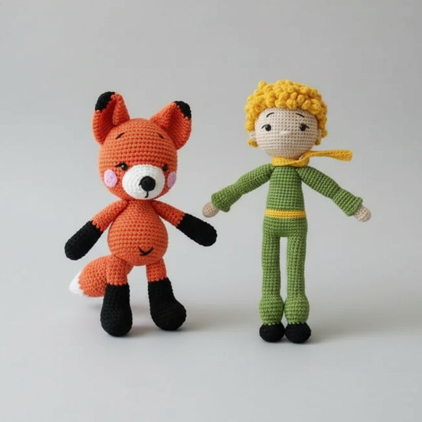Crocheted orange fox and yellow-haired doll sitting in heart-patterned gift box