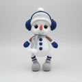 Crocheted snowman with blue earmuffs, scarf, and buttons, standing on a white background