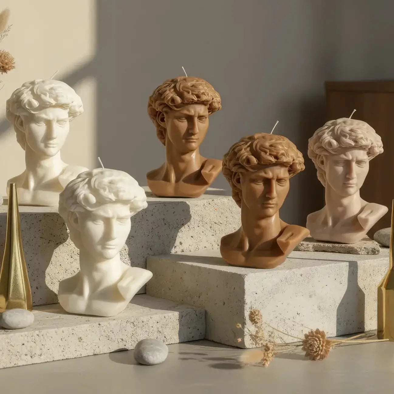 Collection of classical busts and decorative elements on a neutral background