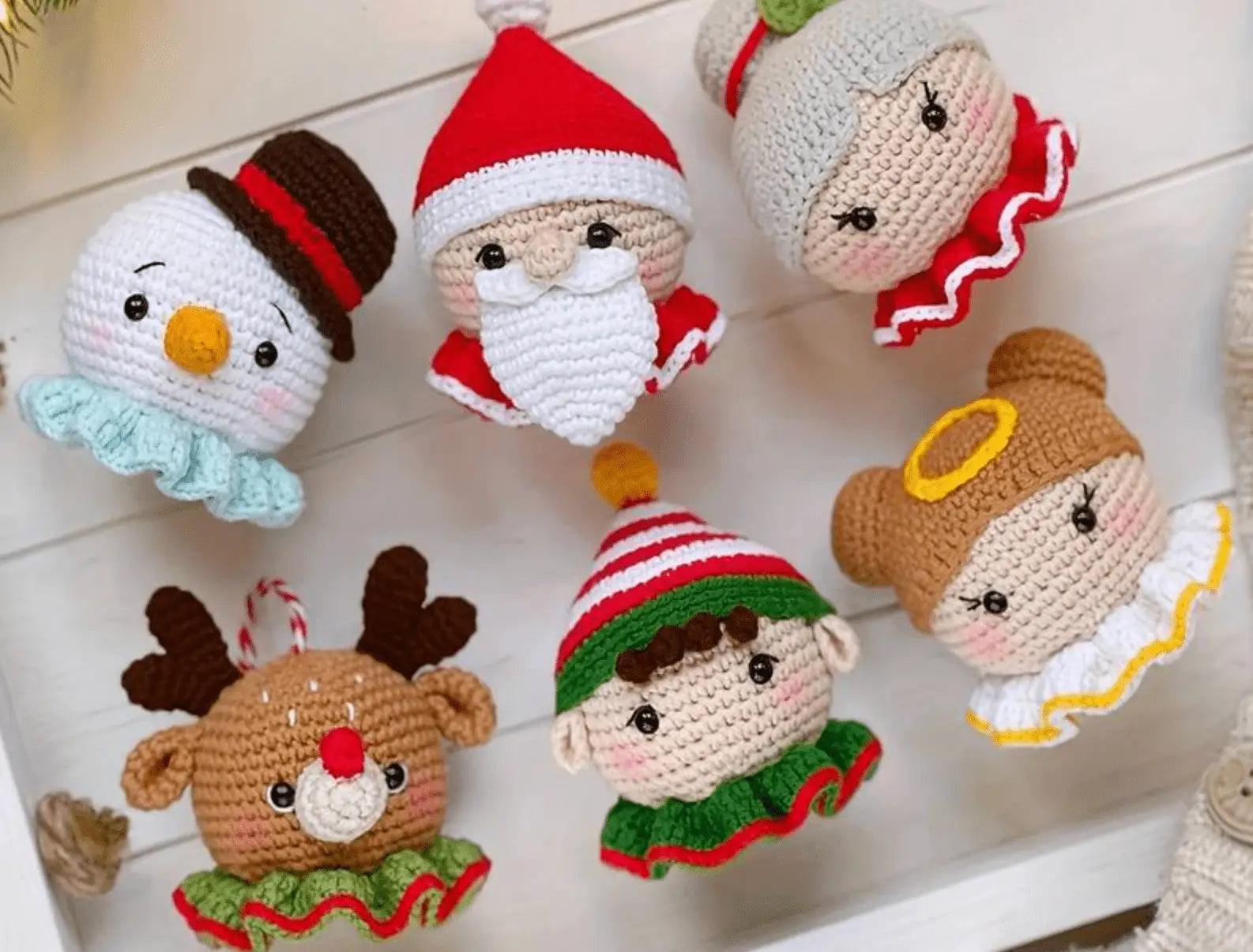 Crocheted Christmas characters: Santa, snowman, elf, reindeer, and angel dolls