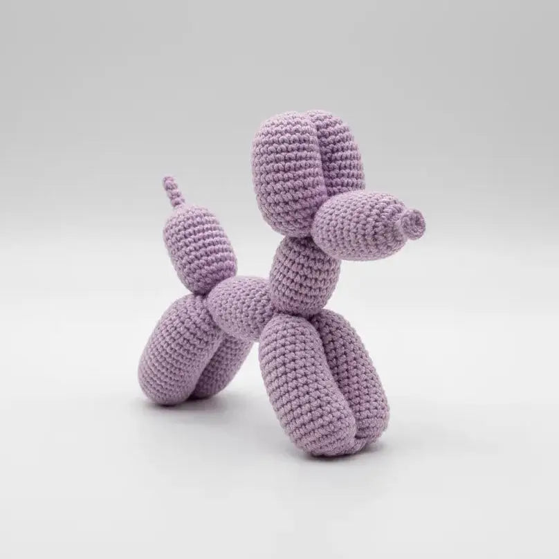 Lavender crocheted balloon dog sculpture on a light background
