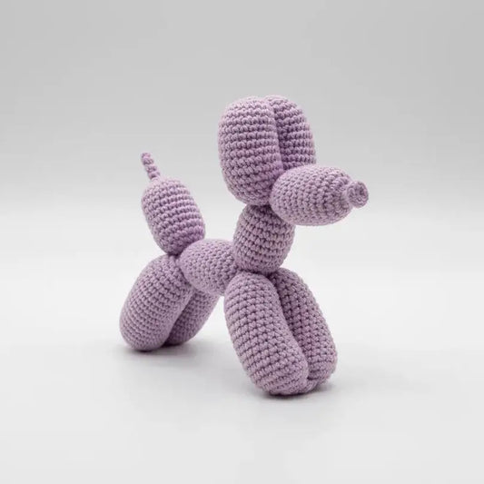 Lavender crocheted balloon dog sculpture on a light background