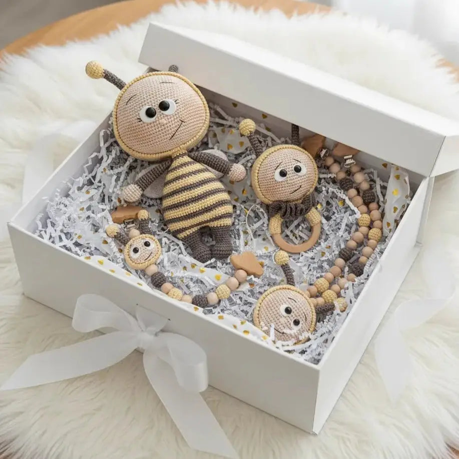 Handmade crocheted bee toys and accessories nestled in a white gift box with ribbon