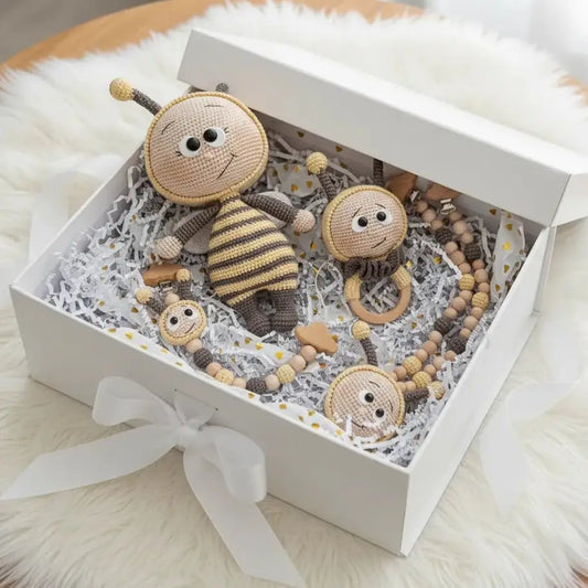 Handmade crocheted bee toys and accessories nestled in a white gift box with ribbon