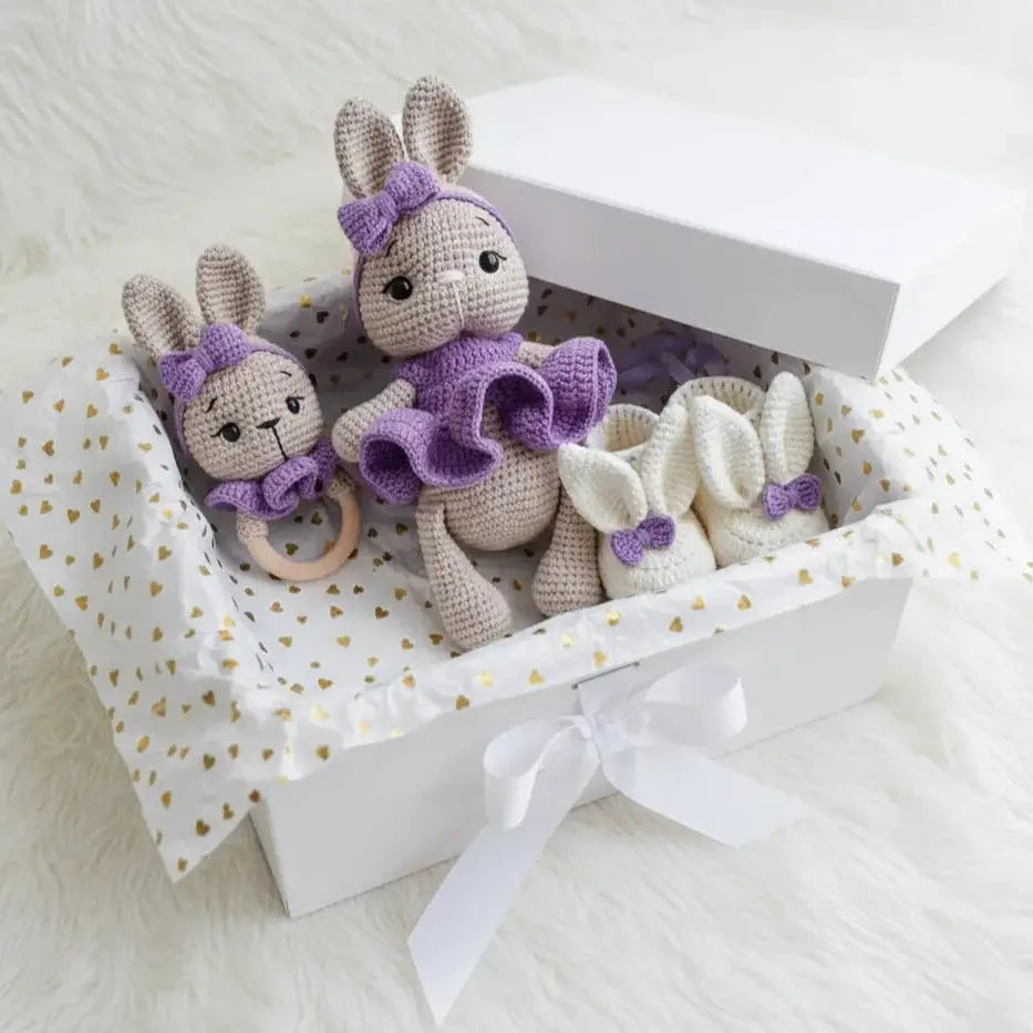 Crocheted purple and gray bunny dolls with matching baby accessories in gift box