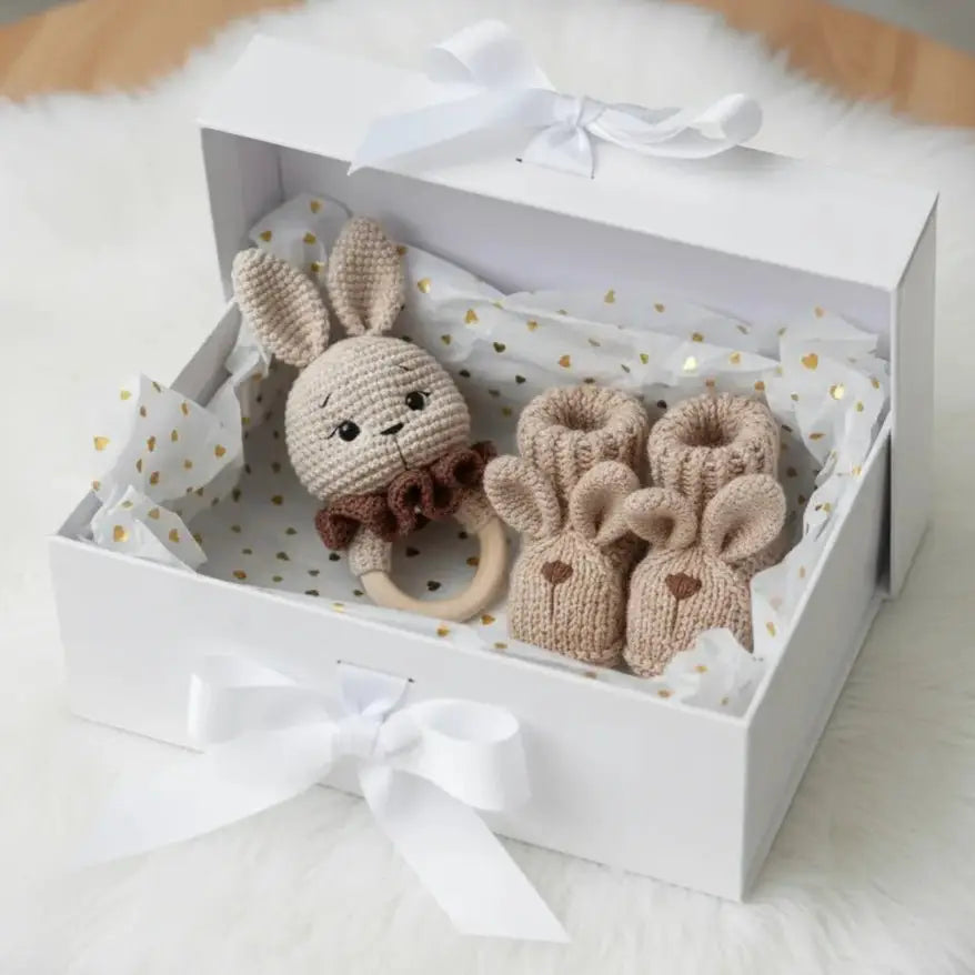 Handmade knitted bunny teether and booties in a white gift box with gold hearts