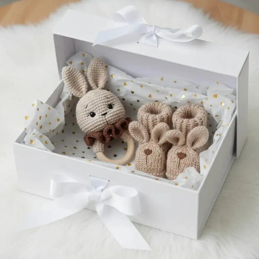 Handmade knitted bunny teether and booties in a white gift box with gold hearts