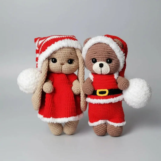 Two crocheted stuffed animals in festive Christmas outfits, a bunny and a bear.