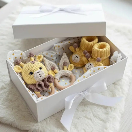 Handmade crochet baby gift set with yellow giraffe, booties, and wooden teething ring