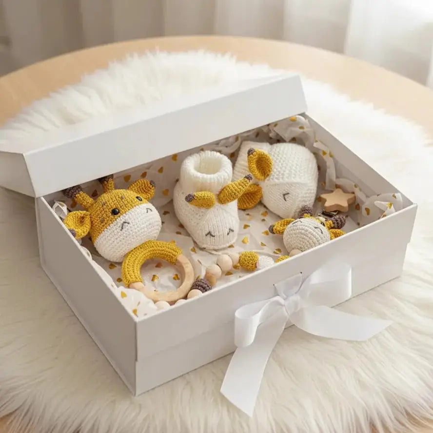 Handmade crochet giraffe baby toys and accessories in a white gift box with ribbon