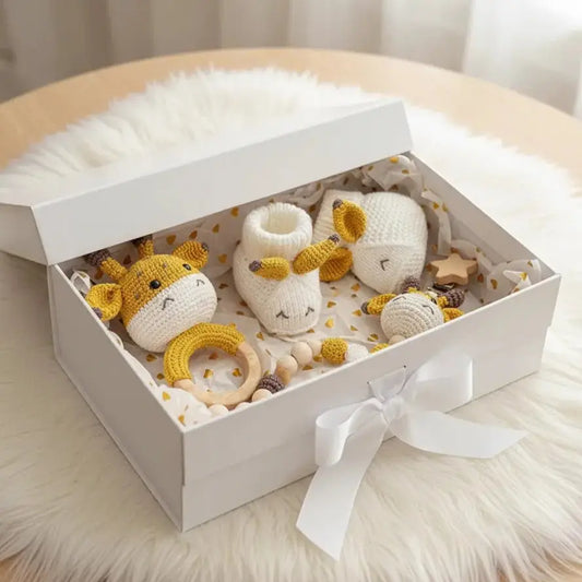 Handmade crochet giraffe baby toys and accessories in a white gift box with ribbon