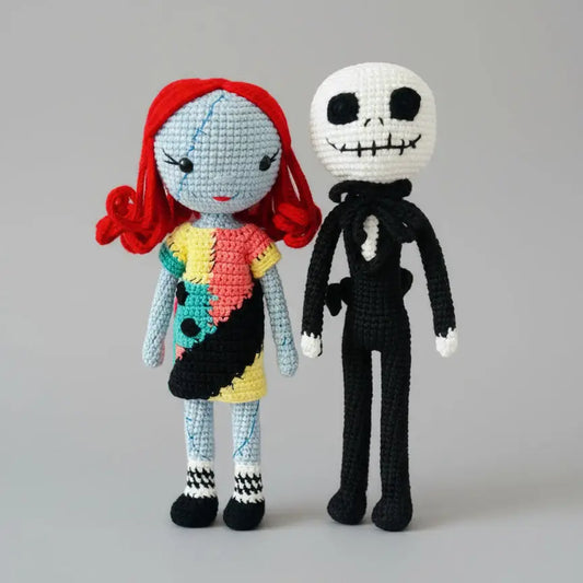 Crocheted Jack and Sally dolls from The Nightmare Before Christmas, standing side by side