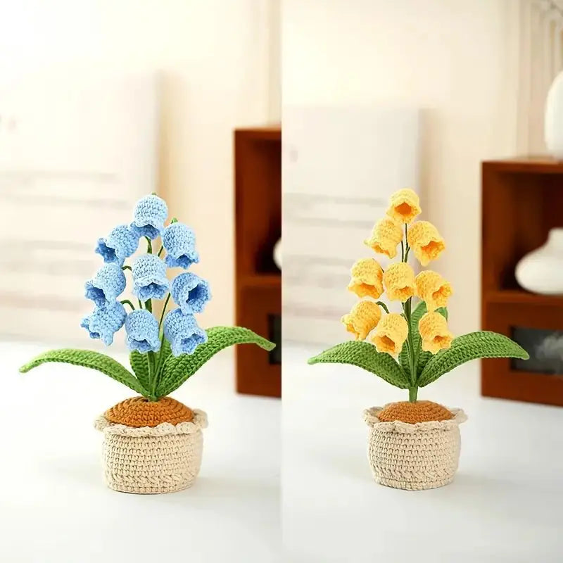 Crocheted blue and yellow bell-shaped flowers in handmade ceramic pots