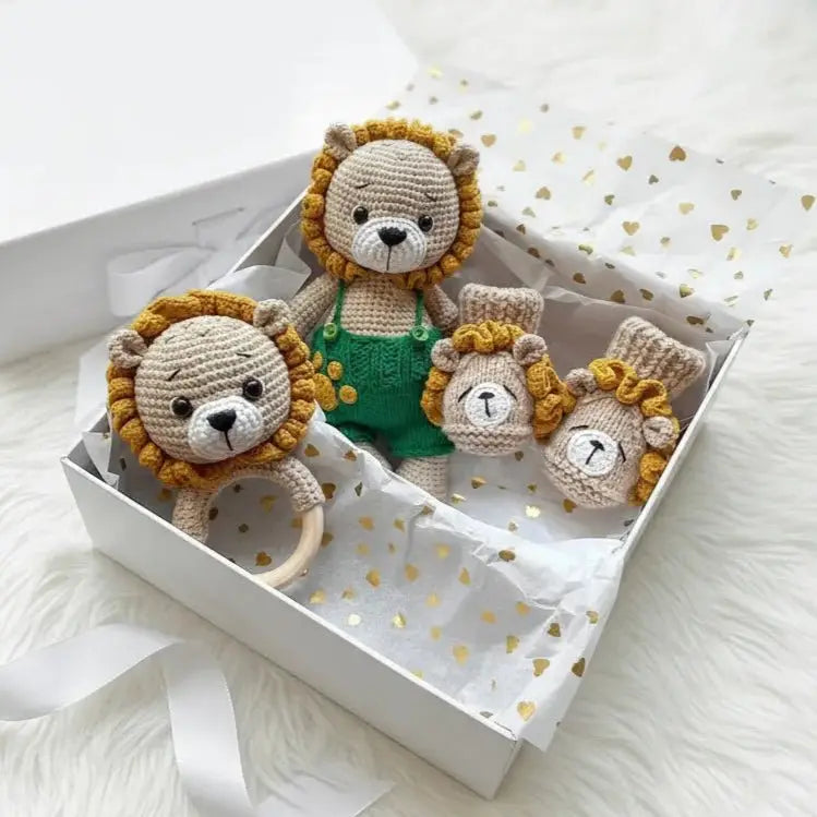 Crochet lion family in a white gift box with gold heart-patterned tissue paper