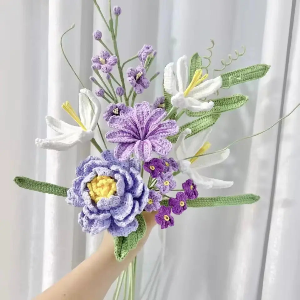 Crocheted bouquet with purple and white flowers, held against soft curtain backdrop
