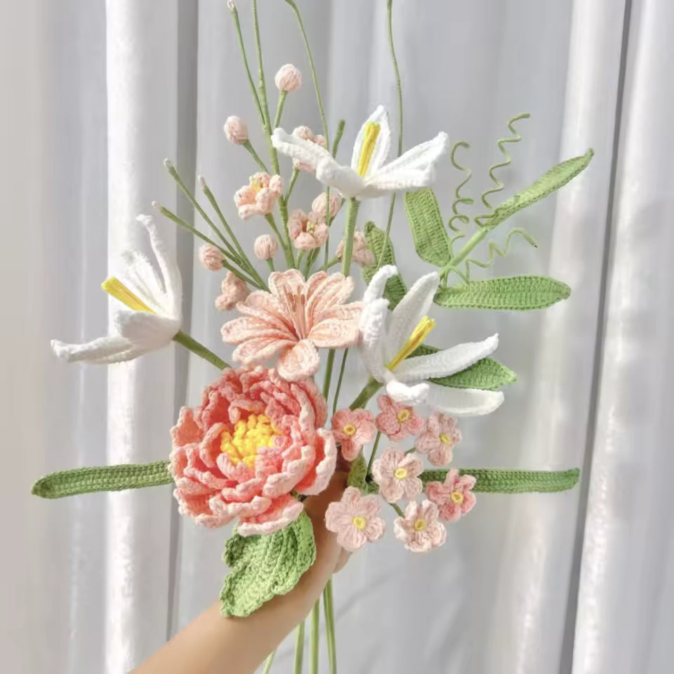 Crocheted bouquet with white lilies, pink peony, and small blush flowers against curtain