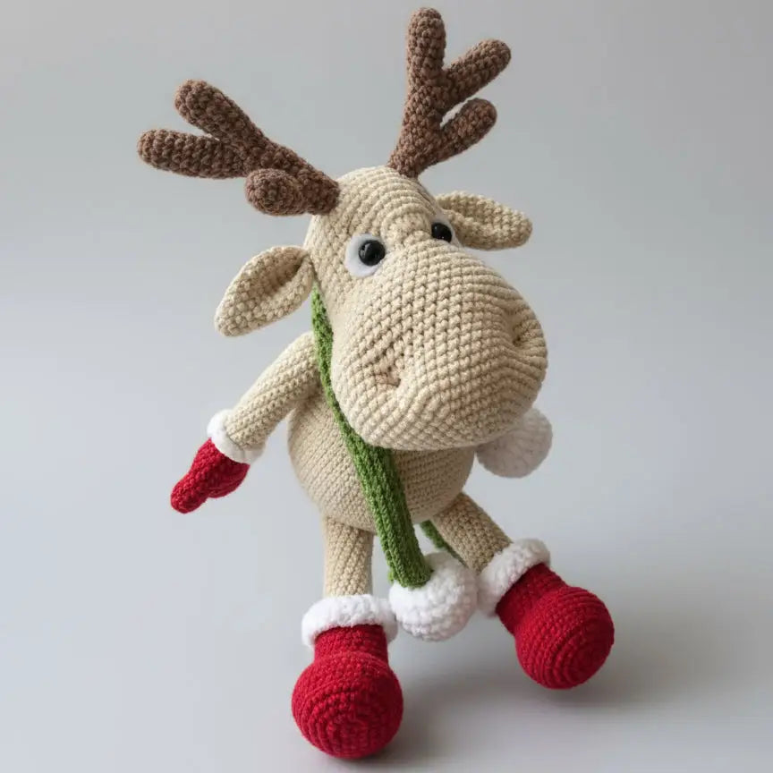 Crocheted reindeer with red boots and green scarf, festive holiday stuffed animal