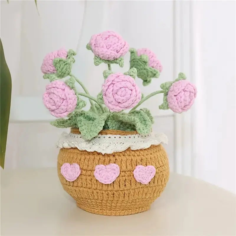 Crocheted pink roses in a yellow pot with heart details and white lace trim