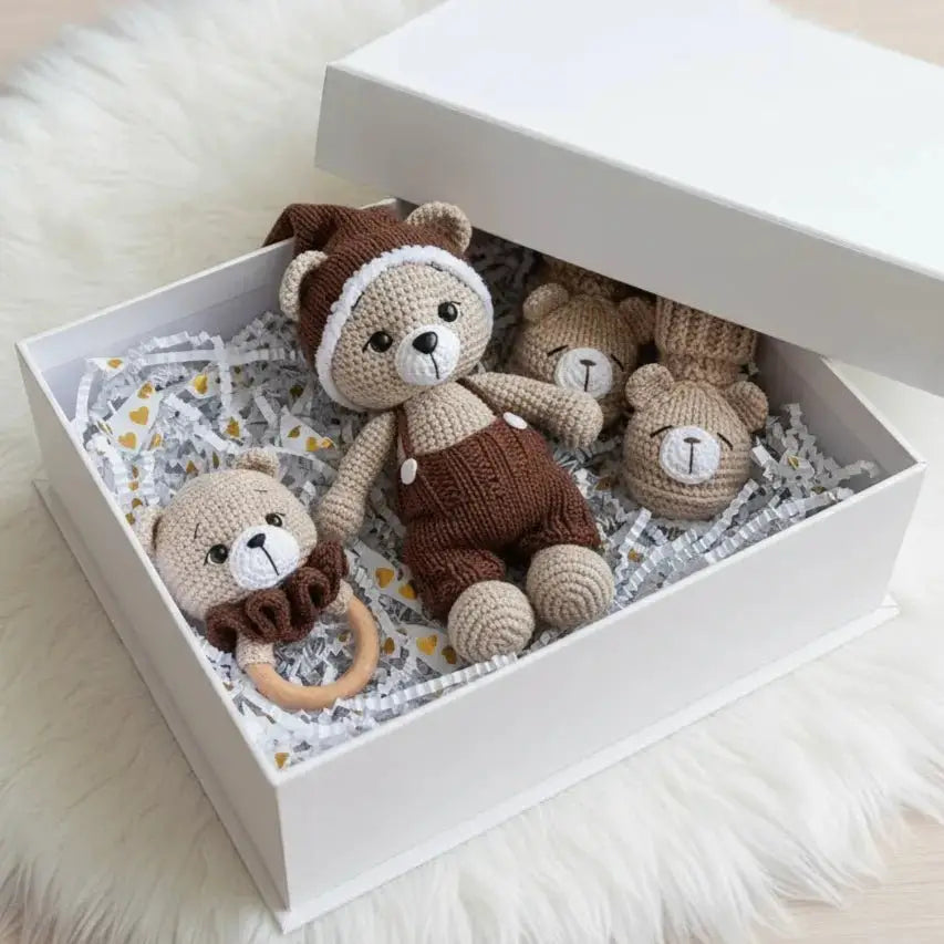 Handmade crocheted teddy bears and baby toy set nestled in a white gift box