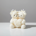 Two white teddy bears holding a heart with rose petals on a dark background