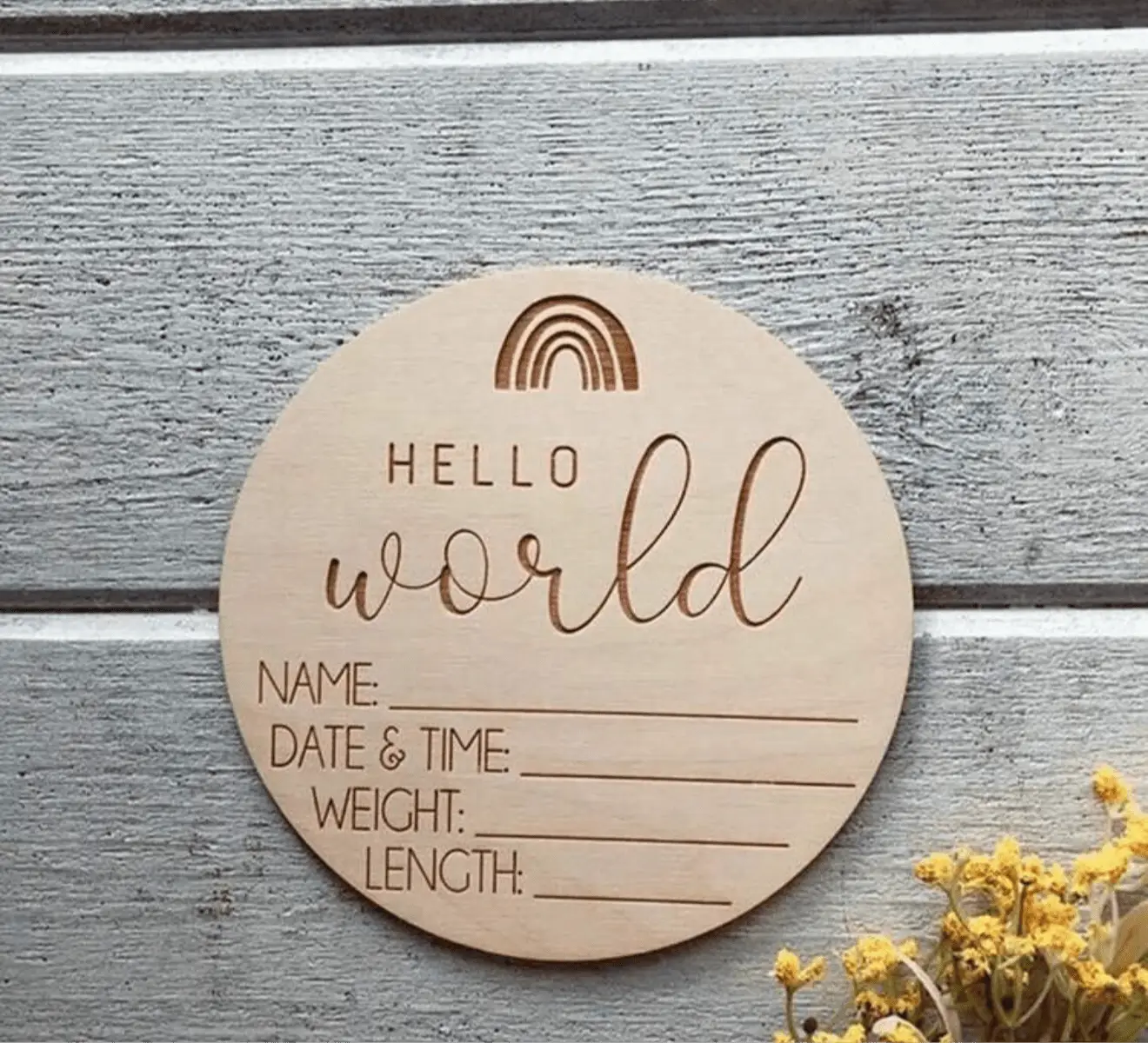Wooden birth announcement sign with "Hello World" and baby details lines
