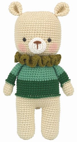 Crocheted teddy bear with green sweater and cute rosy cheeks, standing upright