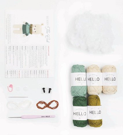 Knitting supplies with pastel yarn skeins, crochet hook, and cute character illustration