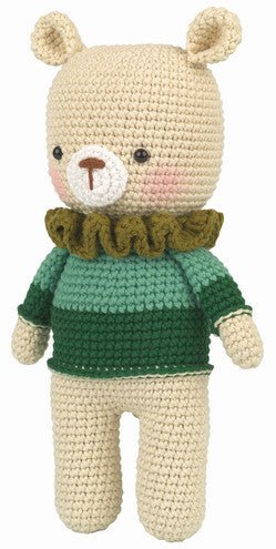 Crocheted teddy bear with green sweater and ruffled collar, standing upright
