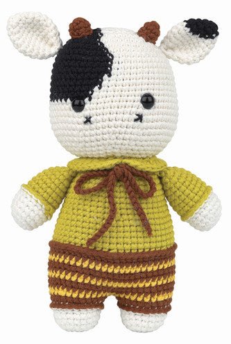 Crocheted cow stuffed animal wearing yellow sweater and brown striped pants