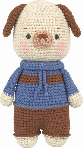 Crocheted puppy plush wearing a blue sweater and brown pants, with rosy cheeks