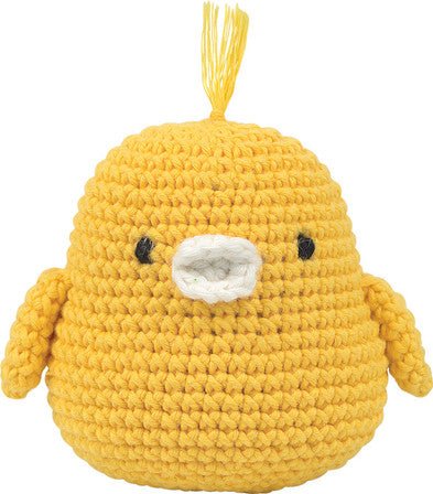 Crocheted yellow chick with simple black eyes, round and puffy in soft wool yarn