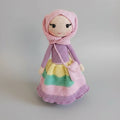 Crocheted doll in pink and purple with colorful layered skirt and hooded bonnet