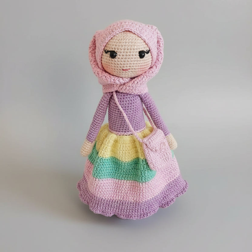 Crocheted doll in pink and purple with colorful layered skirt and hooded bonnet