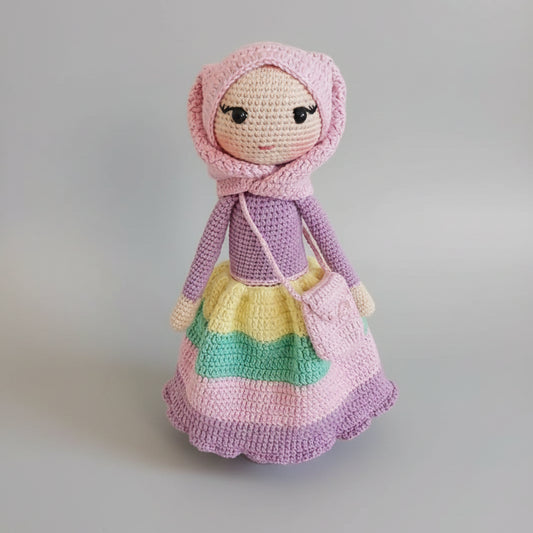 Crocheted doll in pink and purple with colorful layered skirt and hooded bonnet