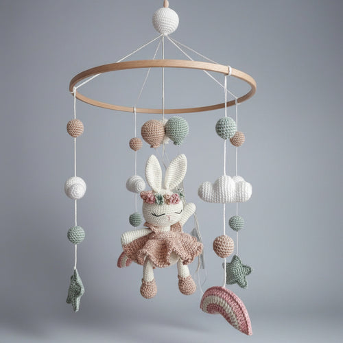 Crocheted baby mobile with bunny, clouds, balls, and stars in pastel colors