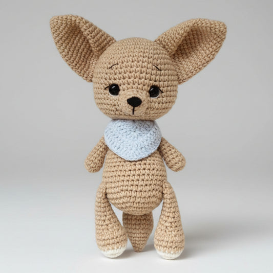 Crocheted tan Chihuahua stuffed animal with blue scarf, standing upright