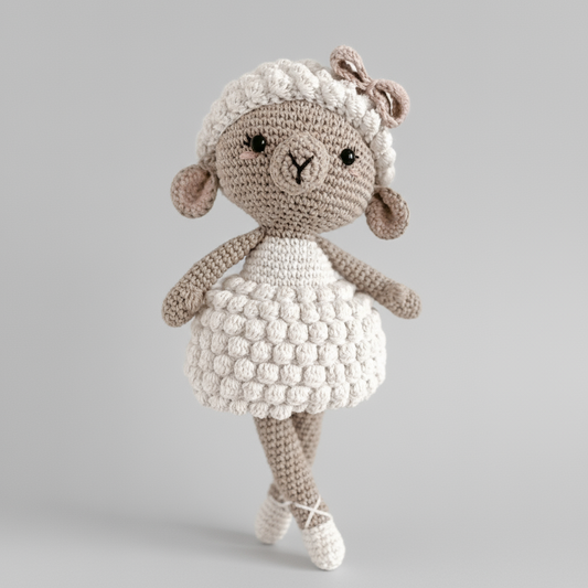 Crocheted lamb doll with fluffy white body, standing on tiptoes against a gray background