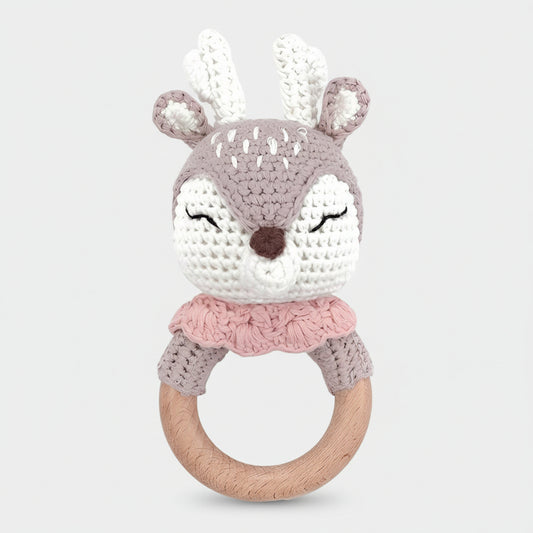Crocheted deer baby rattle with wooden ring in soft gray, white, and pink colors