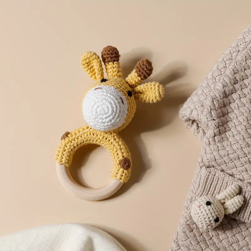 Crocheted giraffe baby teething ring with white ring, yellow and brown yarn