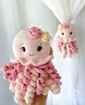 Handmade pink crocheted octopus toys with cute faces and curly tentacles