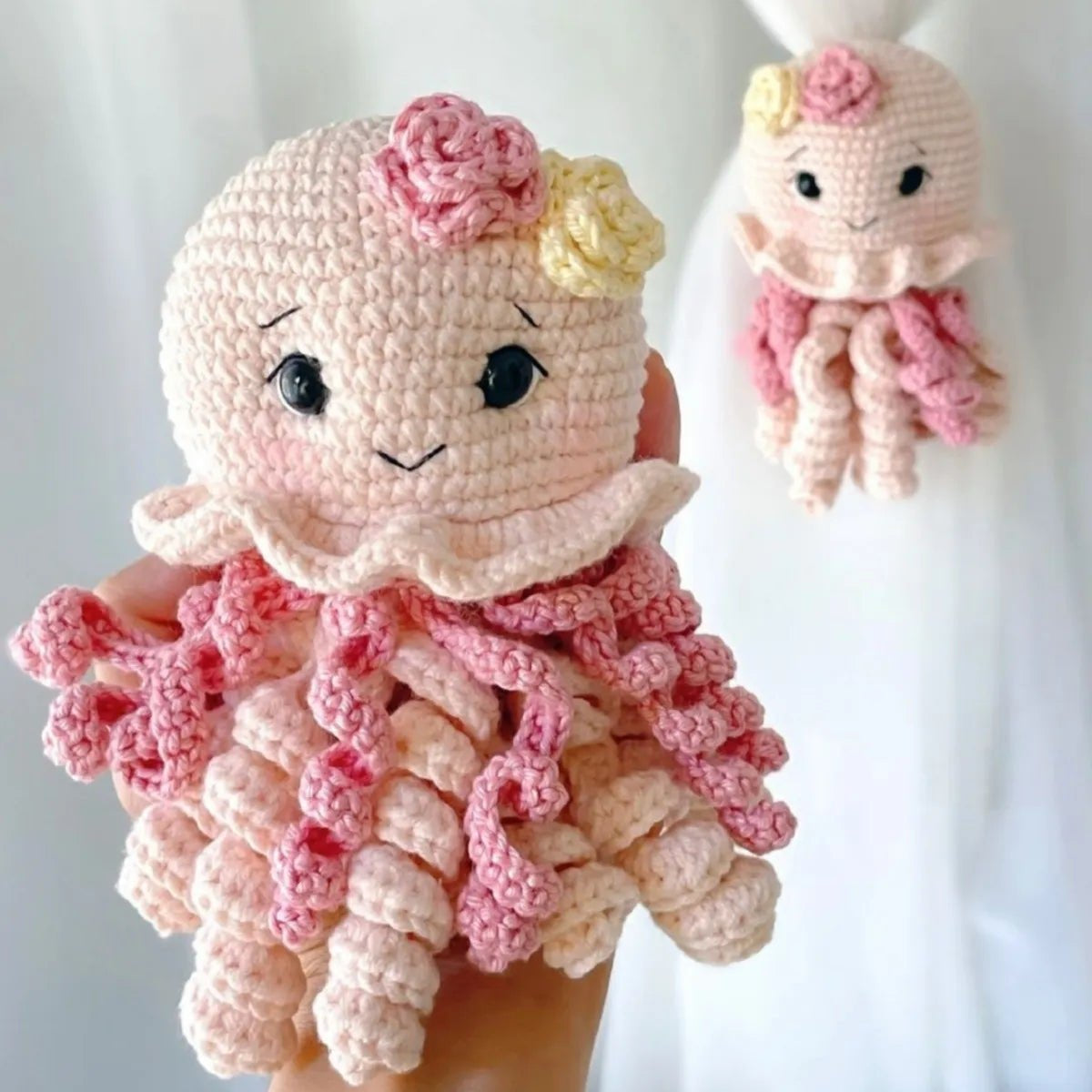 Handmade pink crocheted octopus toys with cute faces and curly tentacles